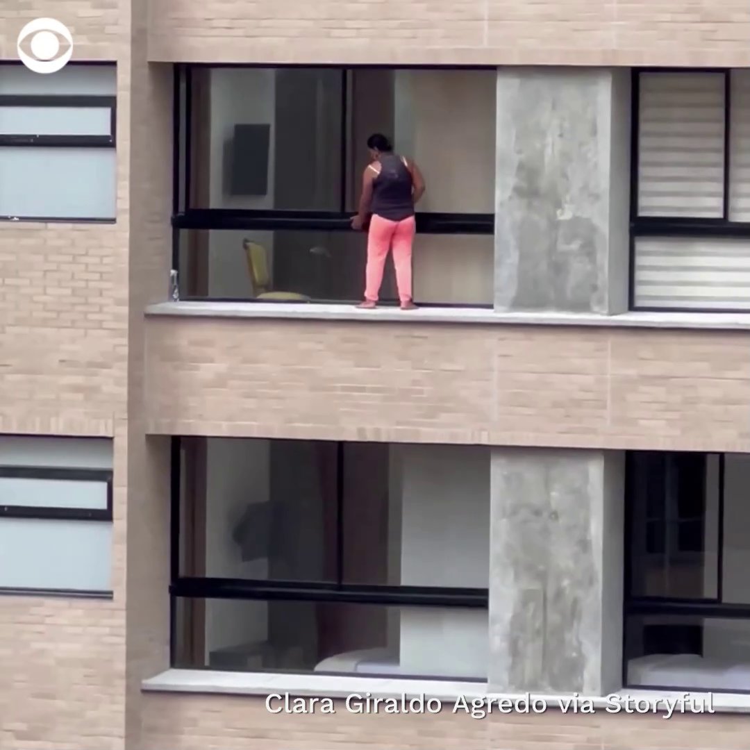 A woman was spotted standing on the ledge of a high-rise apartment building in Medellín, Colombia, cleaning windows on the 12th floor without any kind of safety harness.