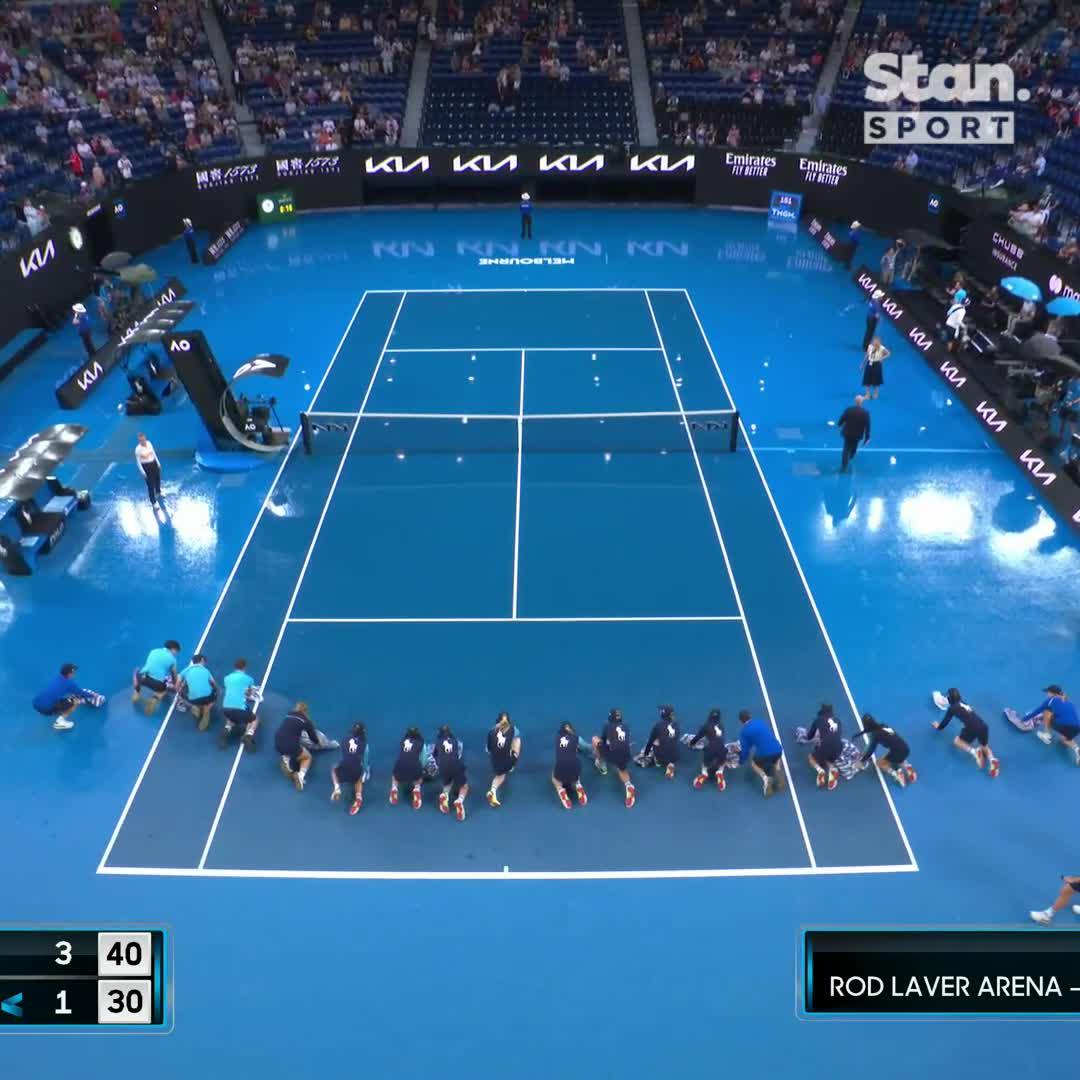 The court-drying army are out again 💪 Rain delays play between Rybakina and Ostapenko in the first set. ↳ Australian Open 2023. Every Match. Ad-free. Centre Court coverage in 4K UHD on Stan Sport. #StanSportAU #AO2023 #AusOpen