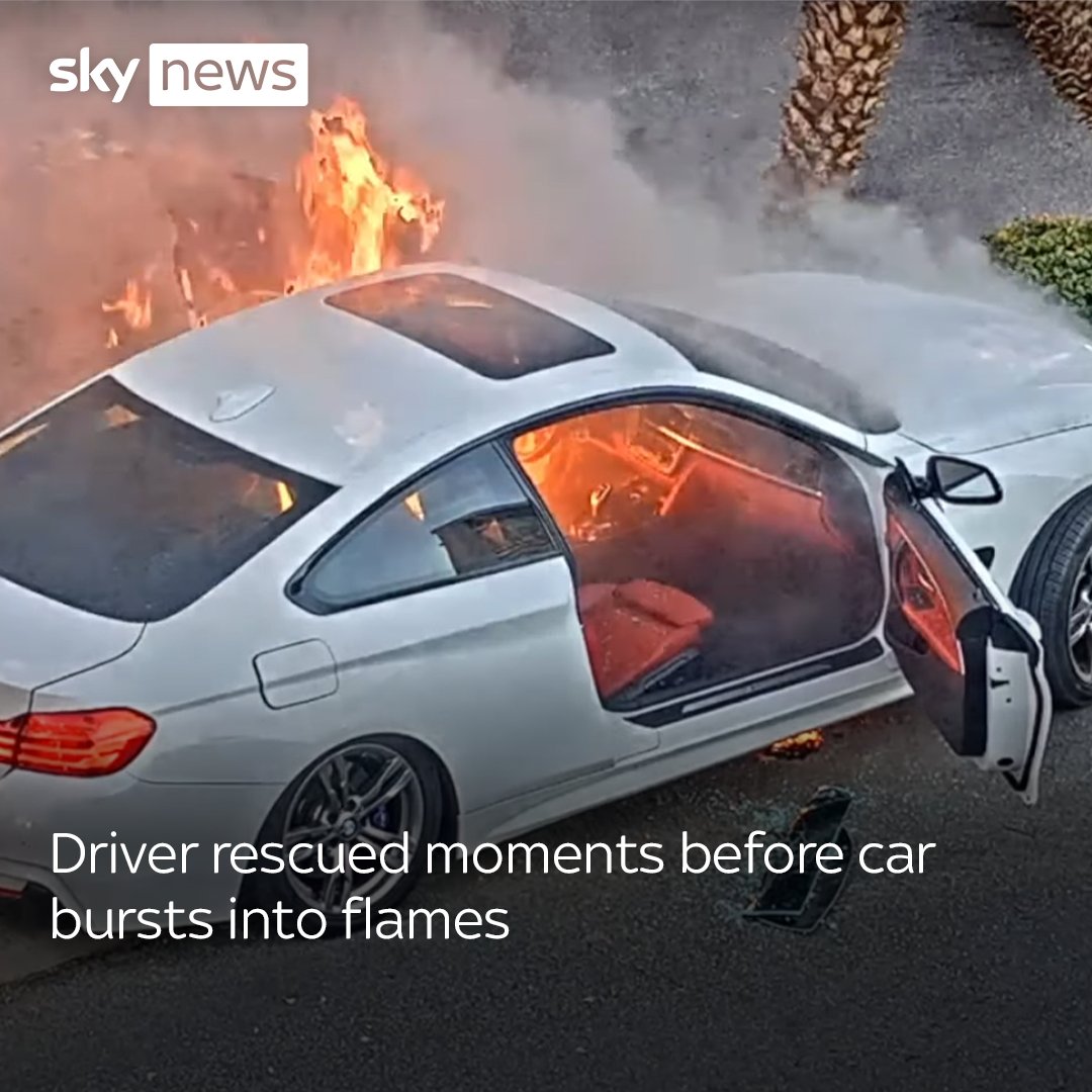 A driver in the United States has been rescued moments before a car burst into flames. Footage published by Las Vegas Metropolitan Police shows an officer and a bystander rescuing the driver. More videos: