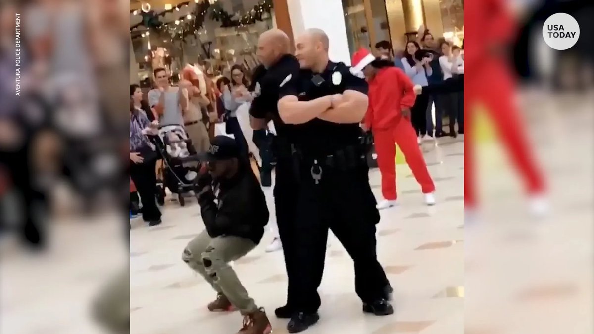 A pair of Florida police officers show off their moves during a flash mob at a Florida mall.