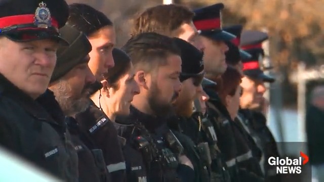 Edmonton Police Service members gathered outside the medical examiner's office to honour Const. Travis Jordan and Const. Brett Ryan, who were killed in the line of duty while responding to a domestic violence call overnight Thursday. #yeg READ MORE: