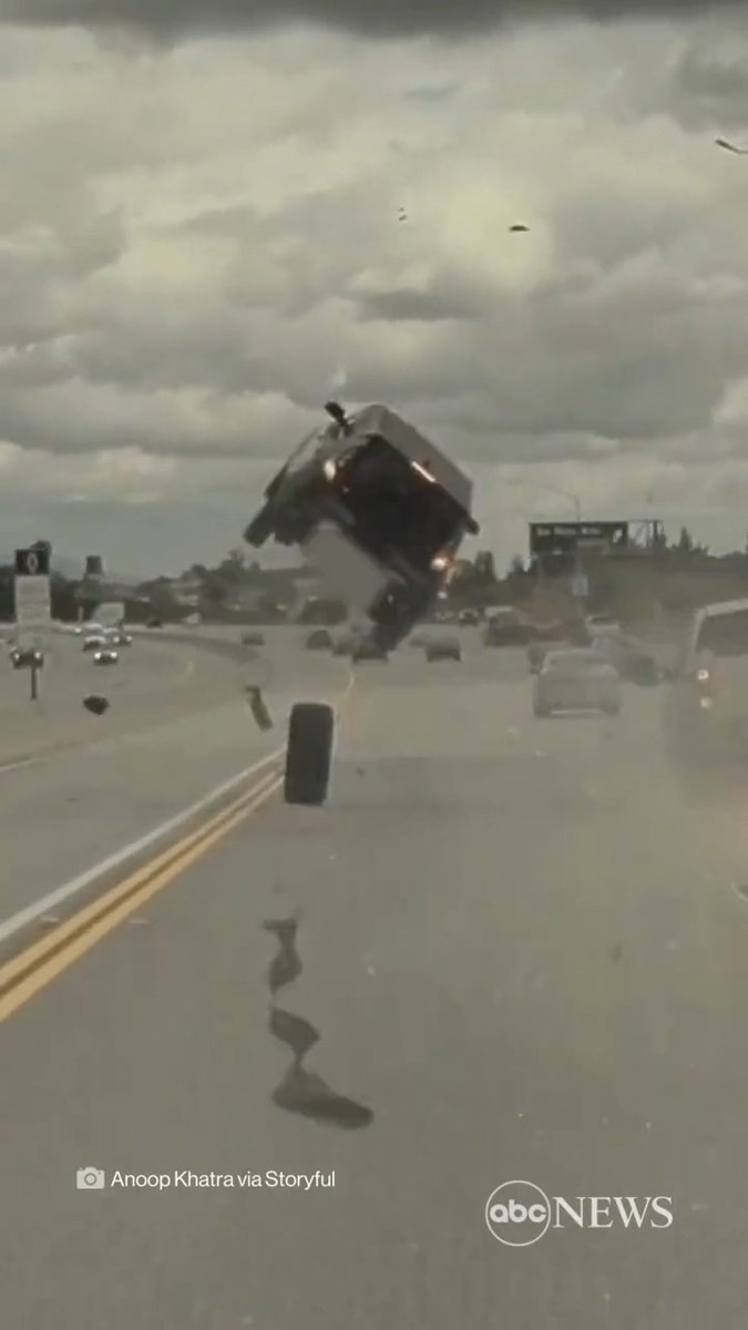 FREEWAY FLIP: A car is sent flying through the air after being struck by a tyre that fell from a nearby truck in Los Angeles. Police said no major injuries were sustained in the incident.