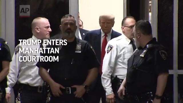 Former President Donald Trump enters a Manhattan courtroom for his arraignment. He is expected to enter a not guilty plea.