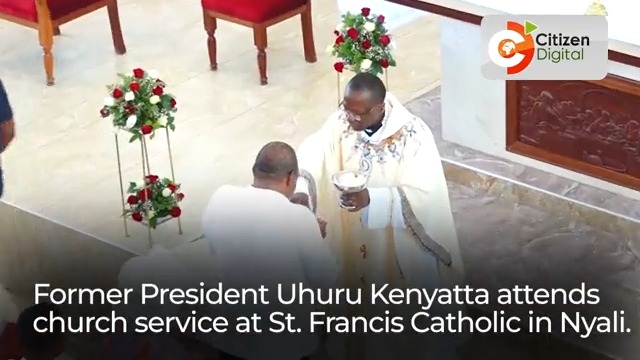 Former President Uhuru Kenyatta tickles Margaret Kenyatta’s shoulder after receiving sacrament