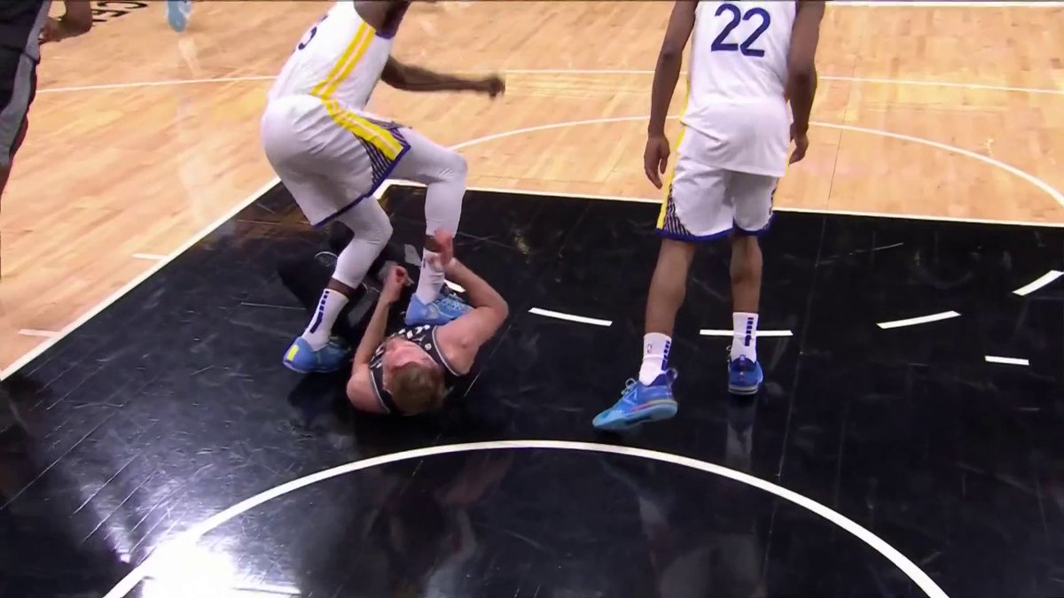 Draymond Green was given a Flagrant 2 after stepping on Domas' chest.