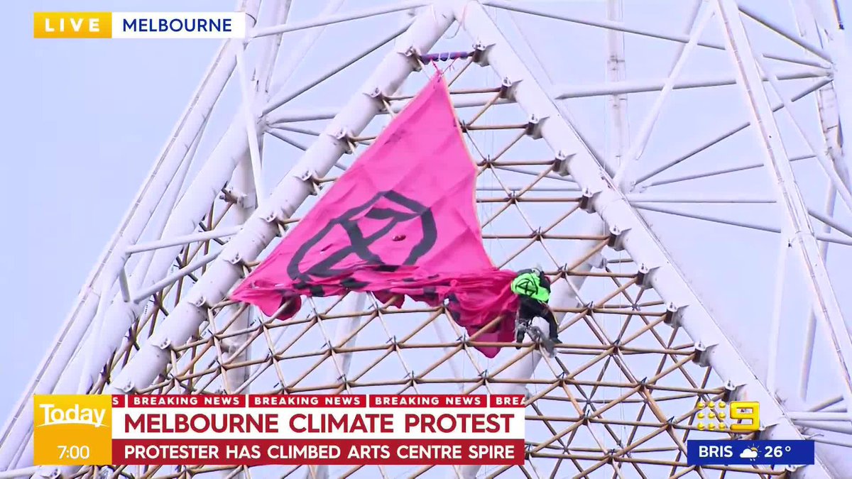 HAPPENING NOW: An extinction rebellion protestor has climbed the arts centre spire in Melbourne and is preparing to drop a giant banner. Izabella Staskowski #9News