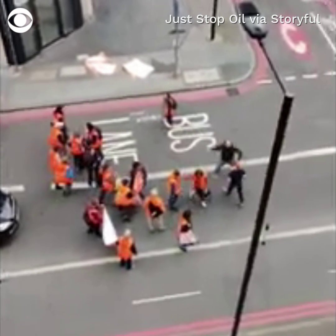 A man in London confronted climate activists who were blocking traffic in London, ripping banners from protesters’ hands and pushing one to the ground.
