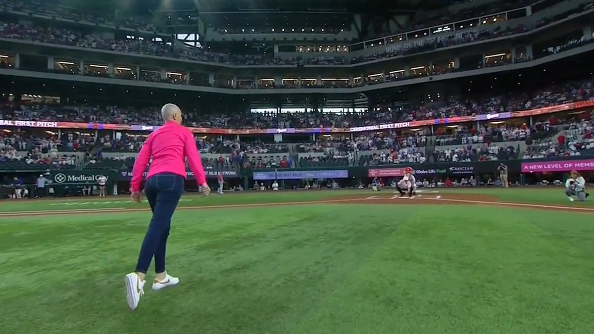 Heartwarming first pitch 💗 Catalina Villegas, Director of Diversity, Equity, and Inclusion for MLB, was diagnosed with breast cancer earlier this year. She was surprised by longtime friend Ivan Pudge Rodriguez for today's first pitch.