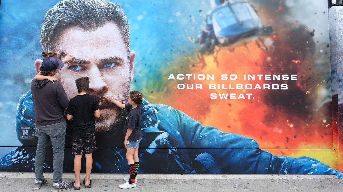 Extraction 2 has such intense action scenes that Chris Hemsworth is even sweating on the billboards!