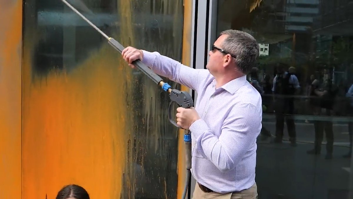 Watch as a member of the public washes off paint from a Just Stop Oil protest, as it carries on around them. #TalkTV