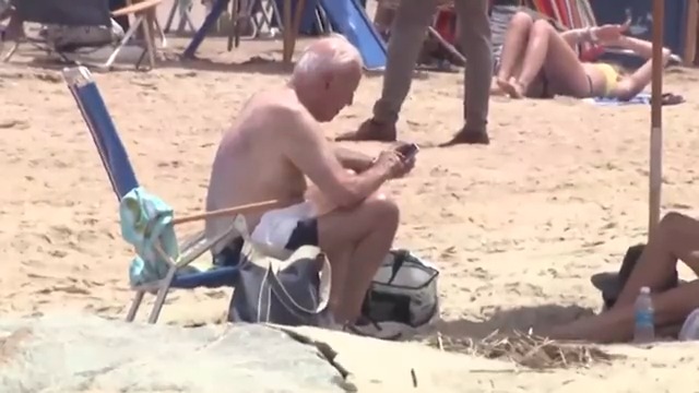 A shirtless Joe Biden enjoys a relaxing day at the beach. Biden has spent 353 days — 39.2% of his presidency — on vacation.