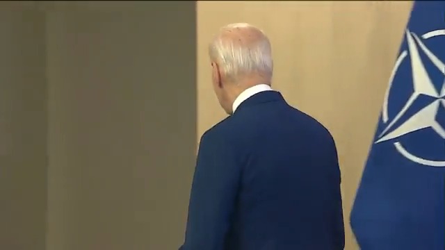 After meeting with NATO Secretary General Jens Stoltenberg, Biden briefly stares at the press before turning around and bumbling away without taking questions