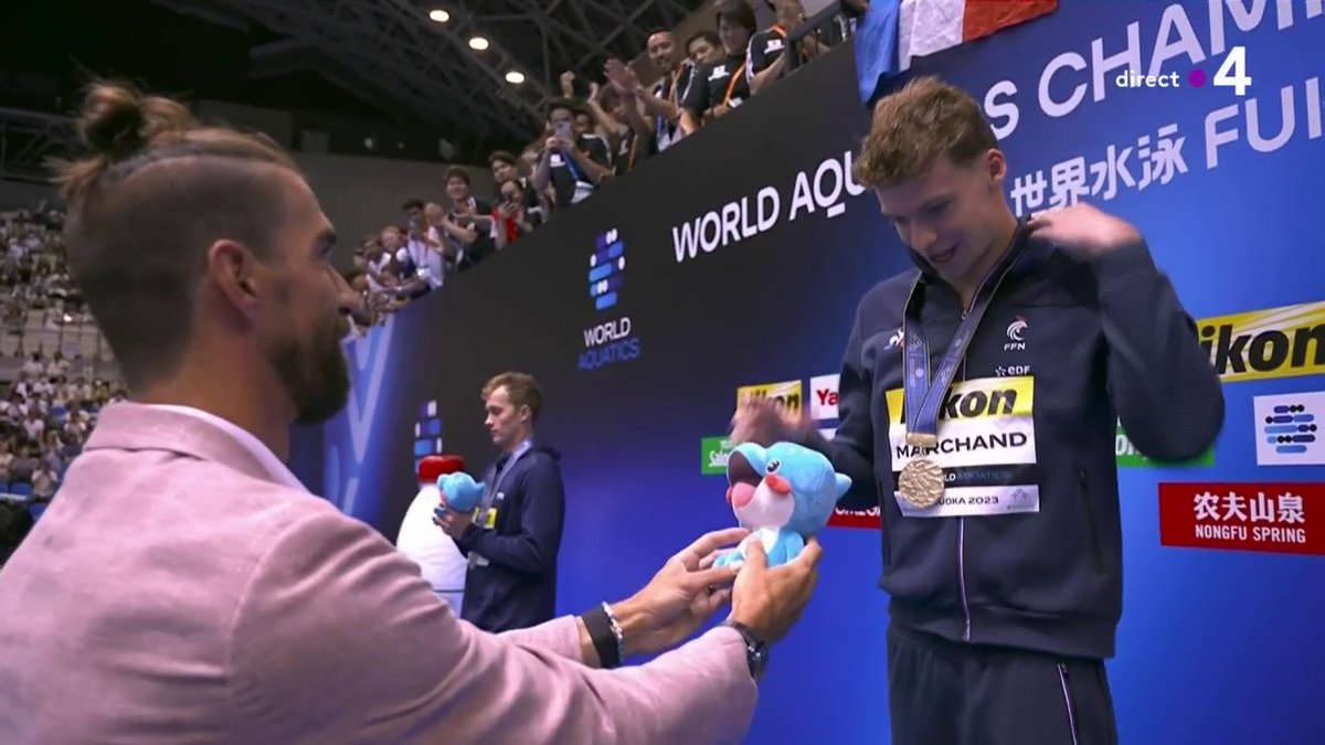 #Fukuoka2023 | Tout un symbole, c'est Michael Phelps en personne qui remet la médaille d'or à Léon Marchand 🤝🥇 ▶️ Le direct :