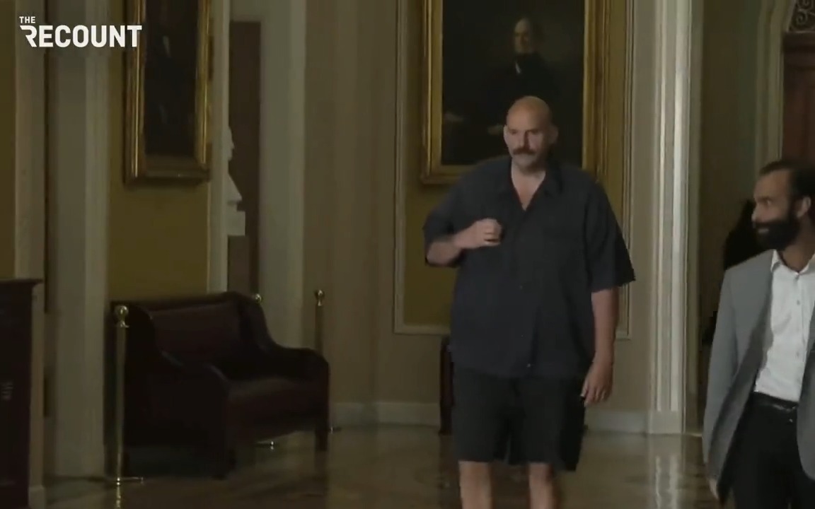 Sen. John Fetterman (D-PA) arrives for the Senate's closed-door meeting with Ukrainian President Volodymyr Zelenskyy in a short-sleeve shirt and shorts.