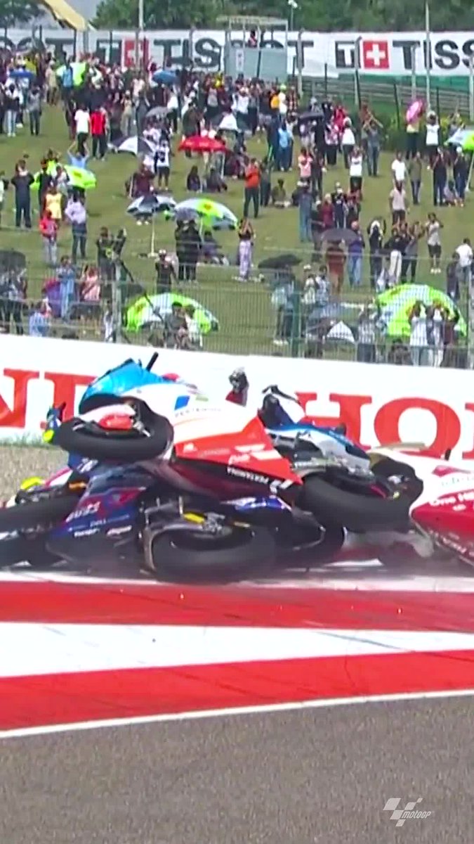 First corner carnage! 🤯 The #Moto2 race was red-flagged before Lap 1 was completed after this crazy multiple-rider crash! 💥 #IndianGP 🇮🇳