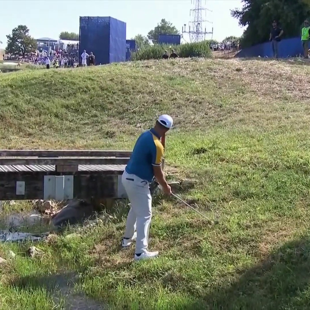 In a stream bank. Bridge in front of you. Deep rough. Ball above the feet. And then he hits that shot 🤯 Jon Rahm is ridiculous