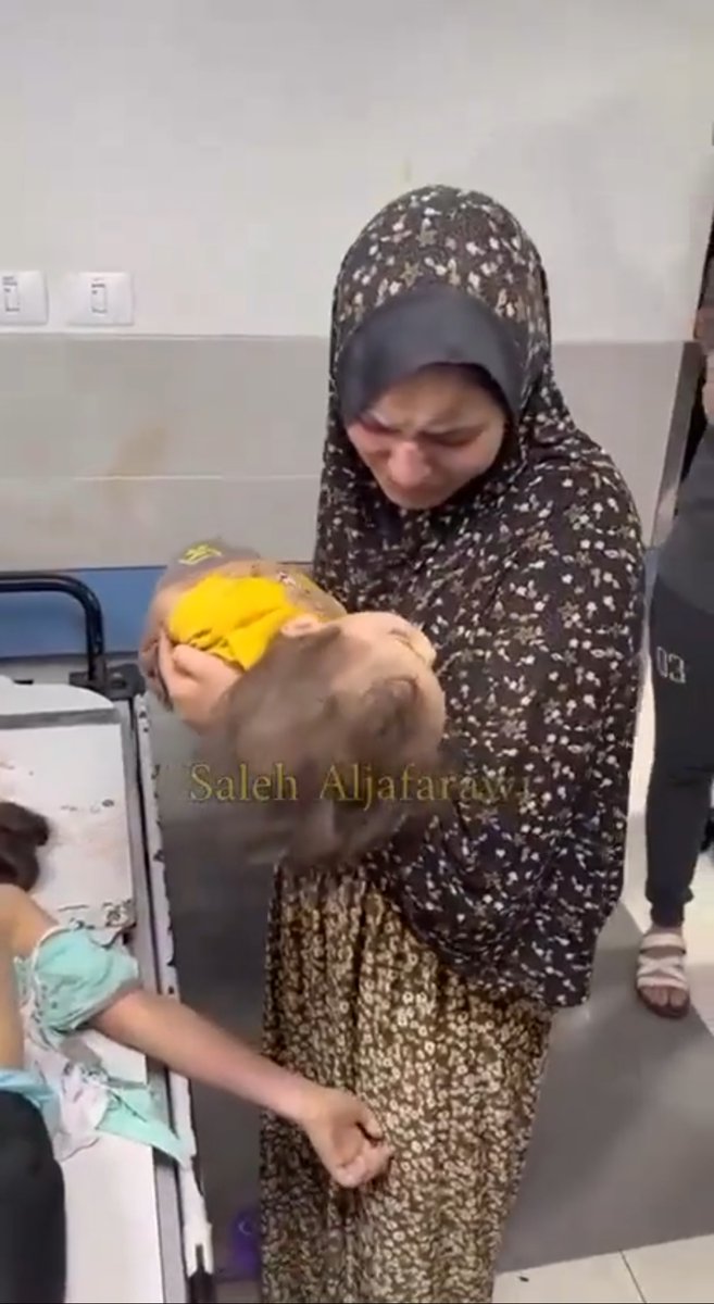 A Palestinian mother bids a final farewell to her two children slaughtered by Israel in airstrikes on Gaza. We can't even begin to imagine what these Palestinian mother's must be going through 💔 their children slaughtered in front of everyone's eyes while the world watches on.