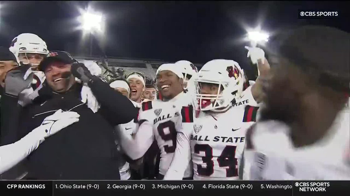 .Ball State Football's Mike Neu celebrated with his team after winning the Bronze Stalk Trophy over Northern Illinois.
