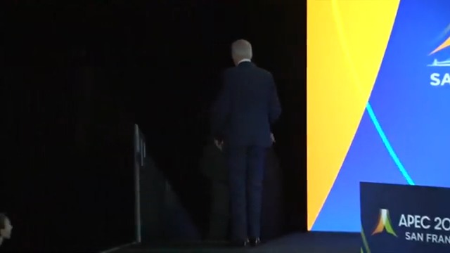 Visibly confused, Biden death grips the hand rail as he exits the stage