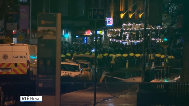 Violent disturbances unfolded in Dublin city centre this evening following a stabbing incident in which three young children and a woman were injured. A garda car was set ablaze following clashes between protestors and the public order unit |