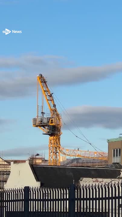 Two people have been injured after a crane collapsed at a building site in Edinburgh.