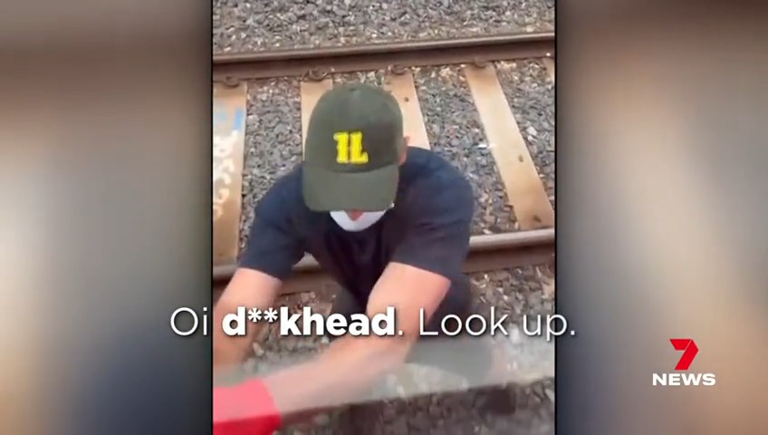 Two vandals have ignored a train load of passengers to brazenly graffitied a train in Melbourne's inner north. #7NEWS