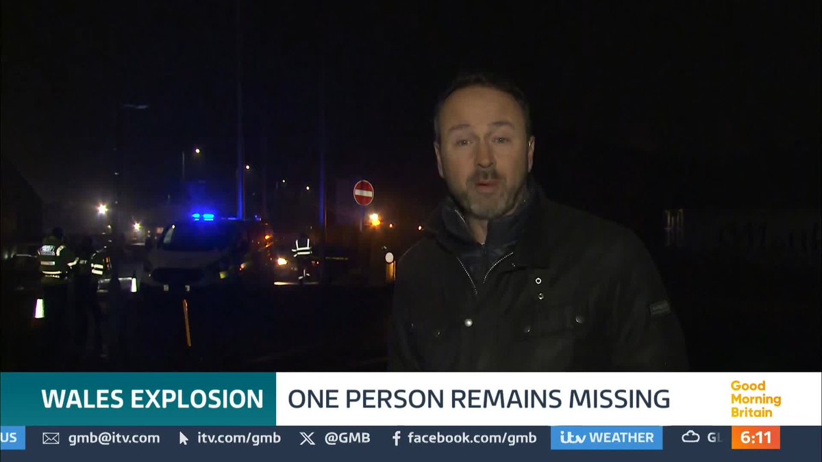 One person is missing and a building has been destroyed after a loud explosion sparked a fire at an industrial estate in South Wales.