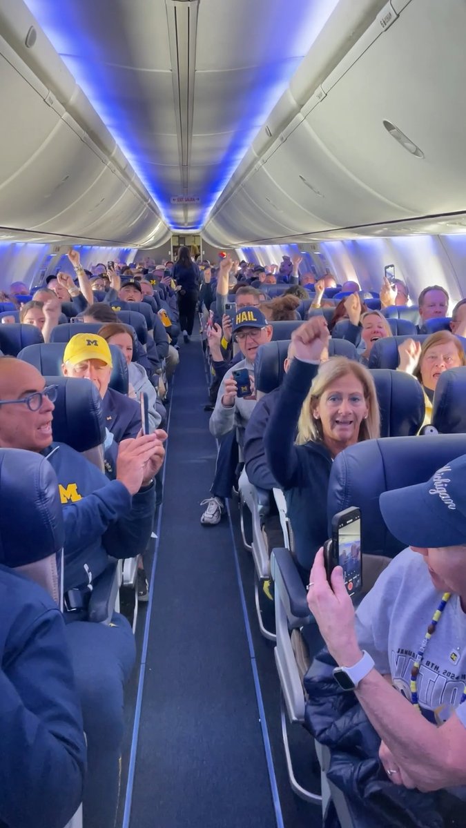 Singing "The Victors" on a plane full of Wolverines en route to the national championship game. Who could possibly have it better than us?!
