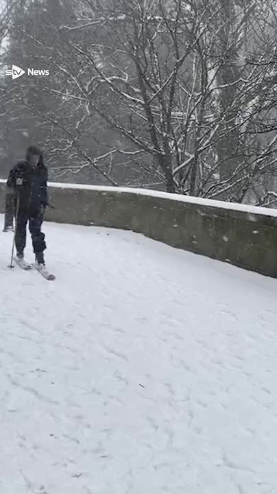 A man in Aberdeen was spotted skiing across the city as snow continues to batter Scotland.