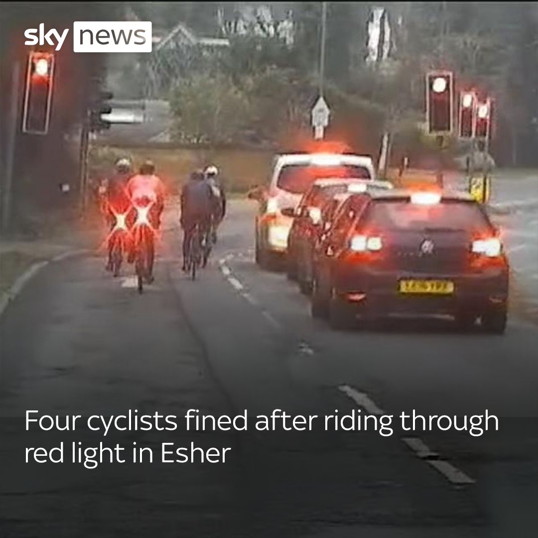 Four cyclists have been fined after they were seen riding through a red light in Esher, Surrey. An unmarked police car was driving directly behind the cyclists and recorded the incident.