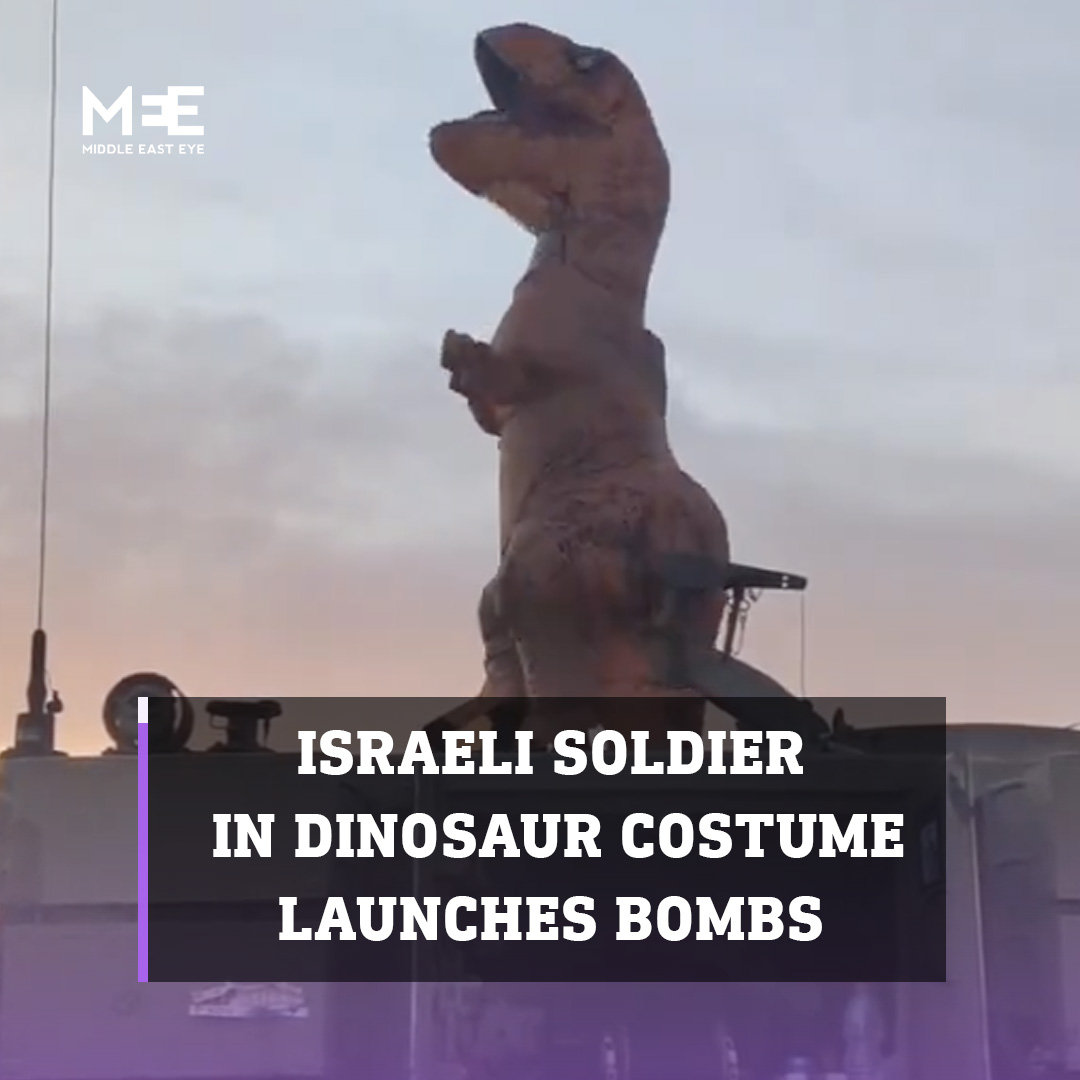 A video circulating on social media shows an Israeli soldier dressed up in a dinosaur costume carrying bombs and launching them into the Gaza strip. He then does a celebratory dance on top of a tank