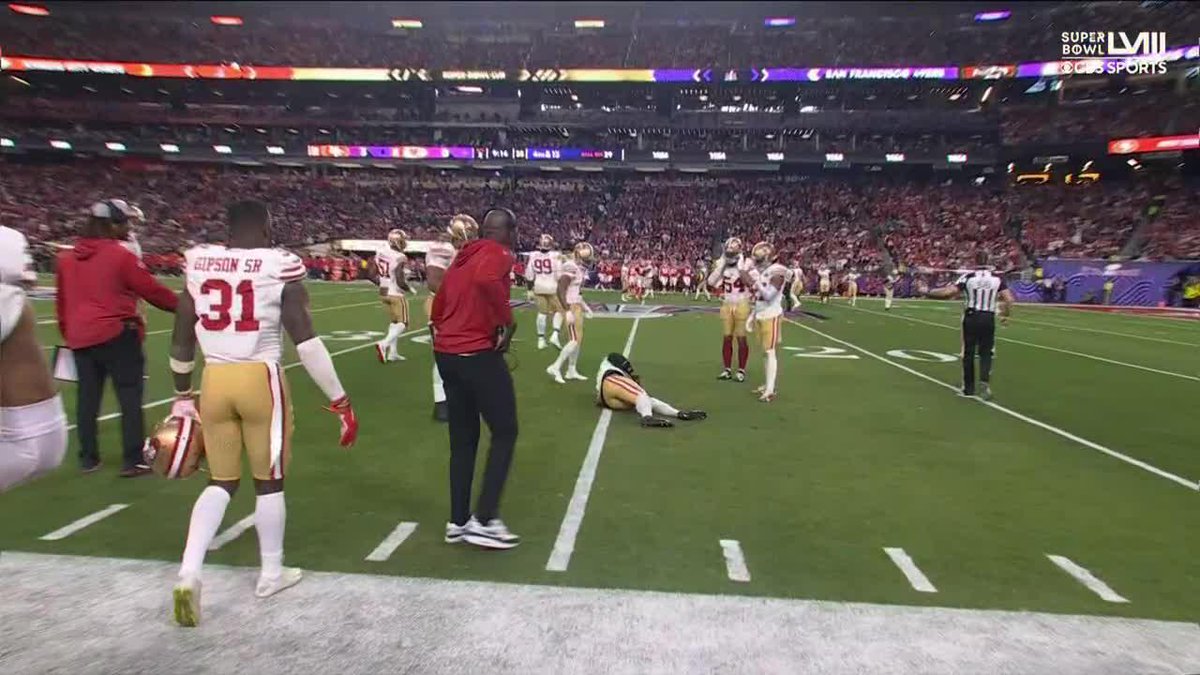 Dre Greenlaw appeared to injure himself jogging back onto the field
