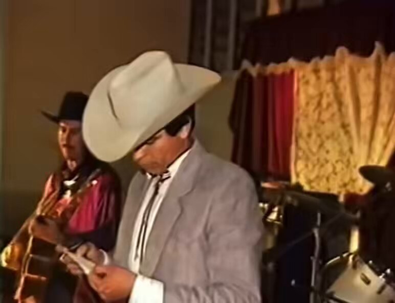 Chalino Sanchez reading the death note handed to him by an audience member, realizing this will be his last performance. He was murdered shortly after performing