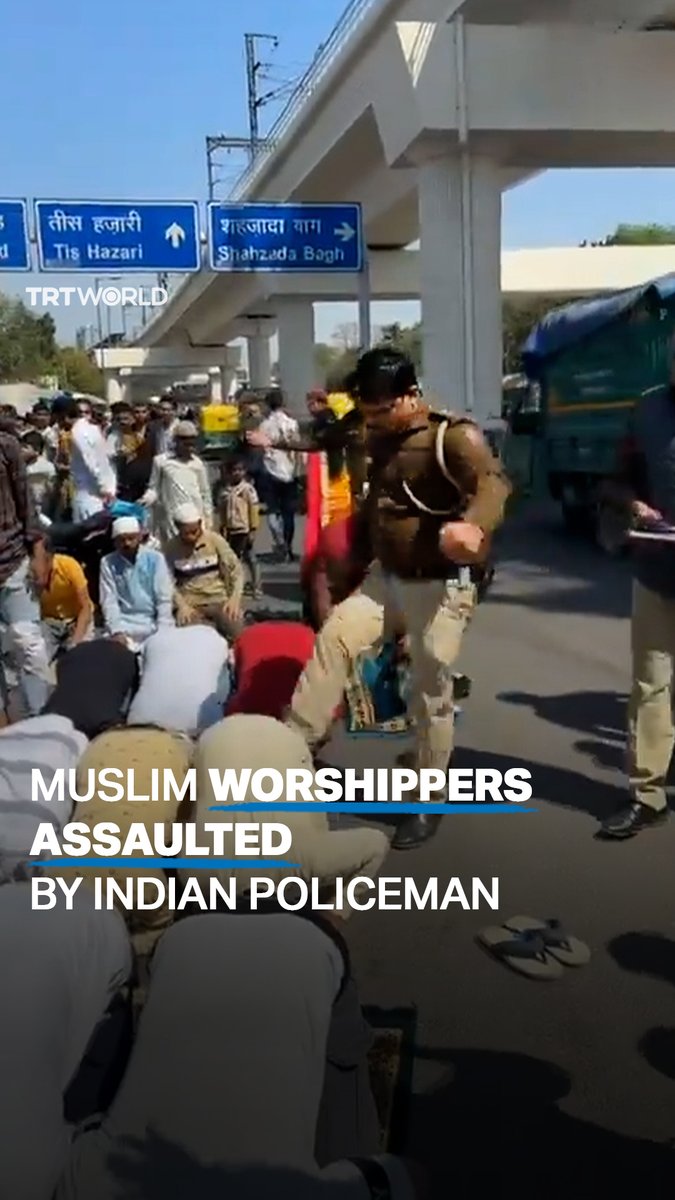 A New Delhi policeman has been suspended after he was caught on camera kicking several Muslim men at a road intersection during Friday prayers