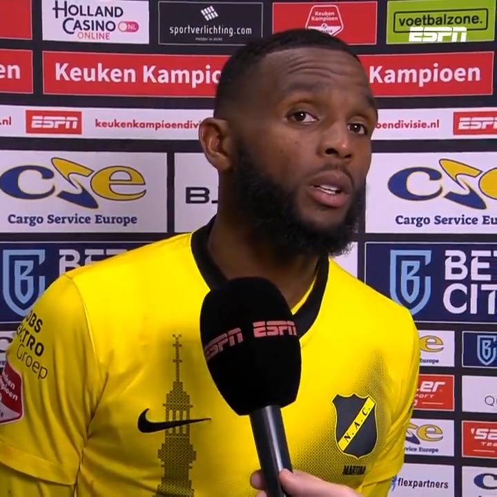 Opmerkelijk moment: NAC-aanvoerder Cuco Martina loopt tijdens een interview weg om teammanager John Karelse in bedwang te houden.