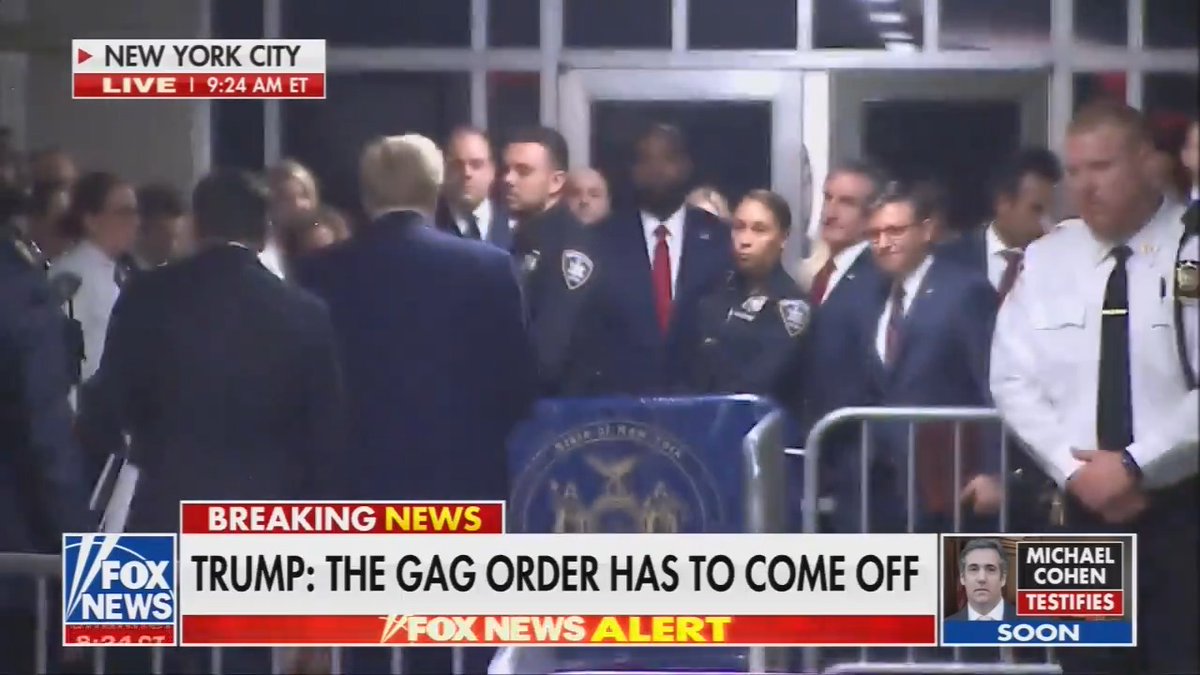 Mike Johnson smiles and nods approvingly at Trump as he heads into his criminal trial