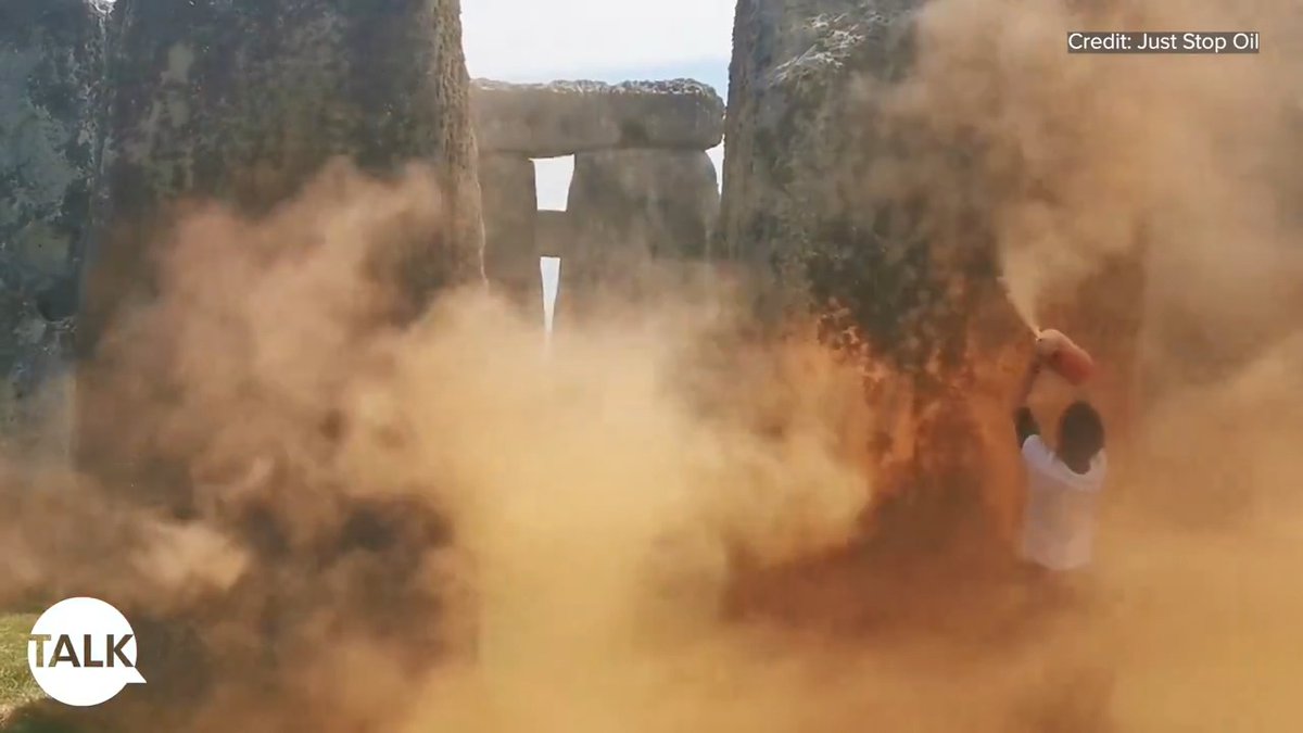 Two Just Stop Oil activists have desecrated Stonehenge with orange powder paint.