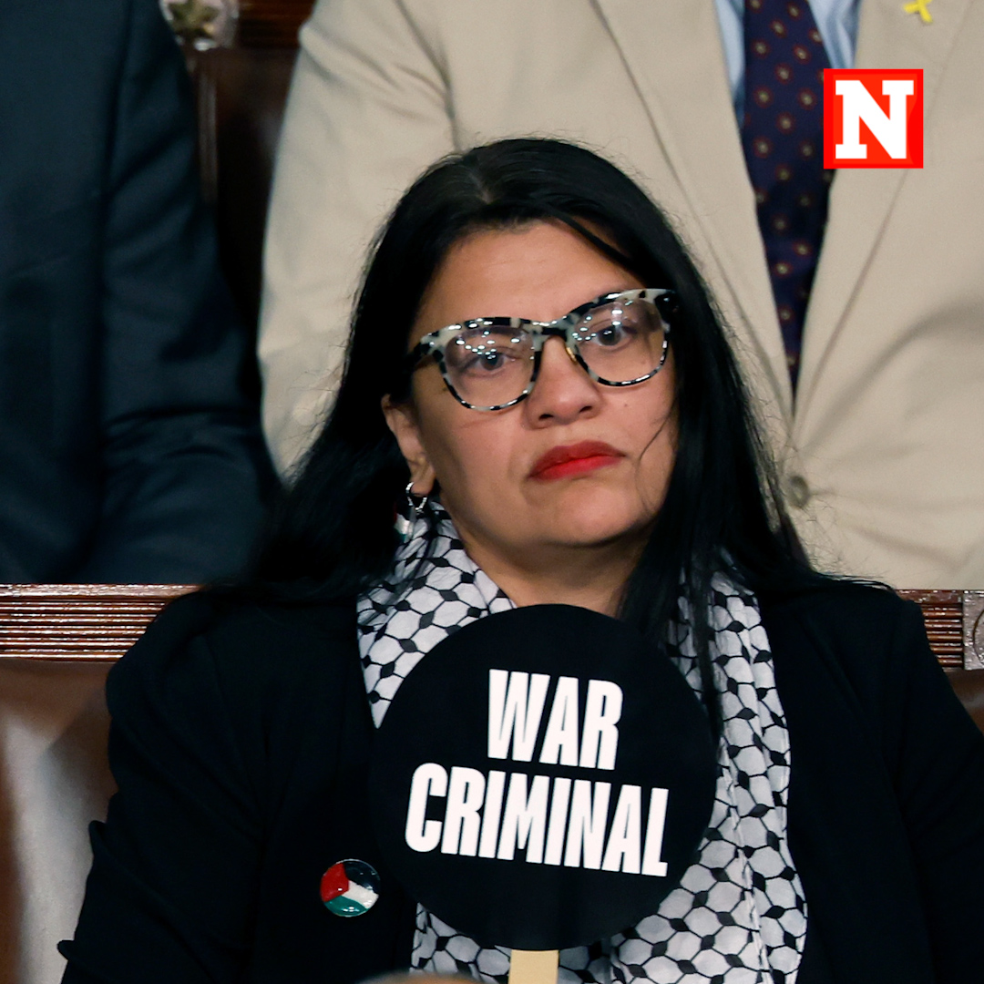 Democratic Rep. Rashida Tlaib holds a sign that reads "War Criminal" as Israeli Prime Minister Benjamin Netanyahu addresses a joint meeting of Congress in the chamber of the House of Representatives.