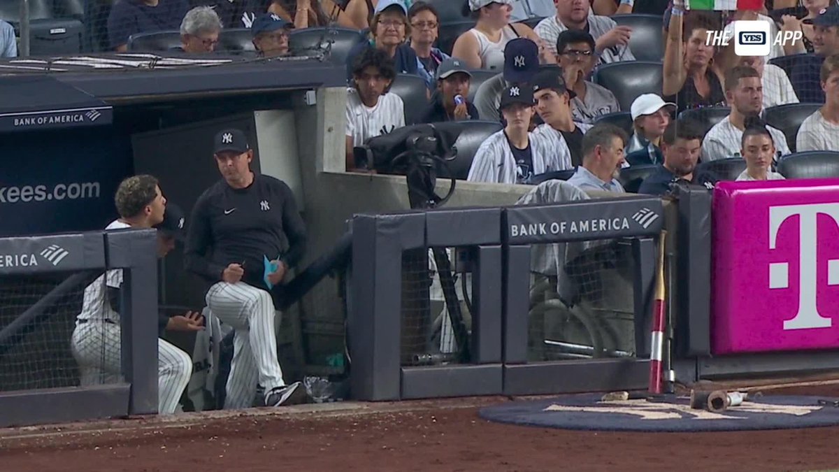 Gleyber Torres and Aaron Boone engage in a discussion in the dugout before being taken out of tonight's game.