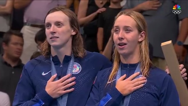 Katie Ledecky invites her teammate Paige Madden on top of the podium during the Star Spangled Banner after the women's 800m free. #ParisOlympics