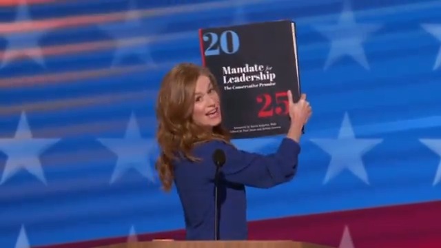 .Mallory McMorrow walks out at Democratic Convention with giant copy of Project 2025 and reads out Trump’s plan to be a dictator