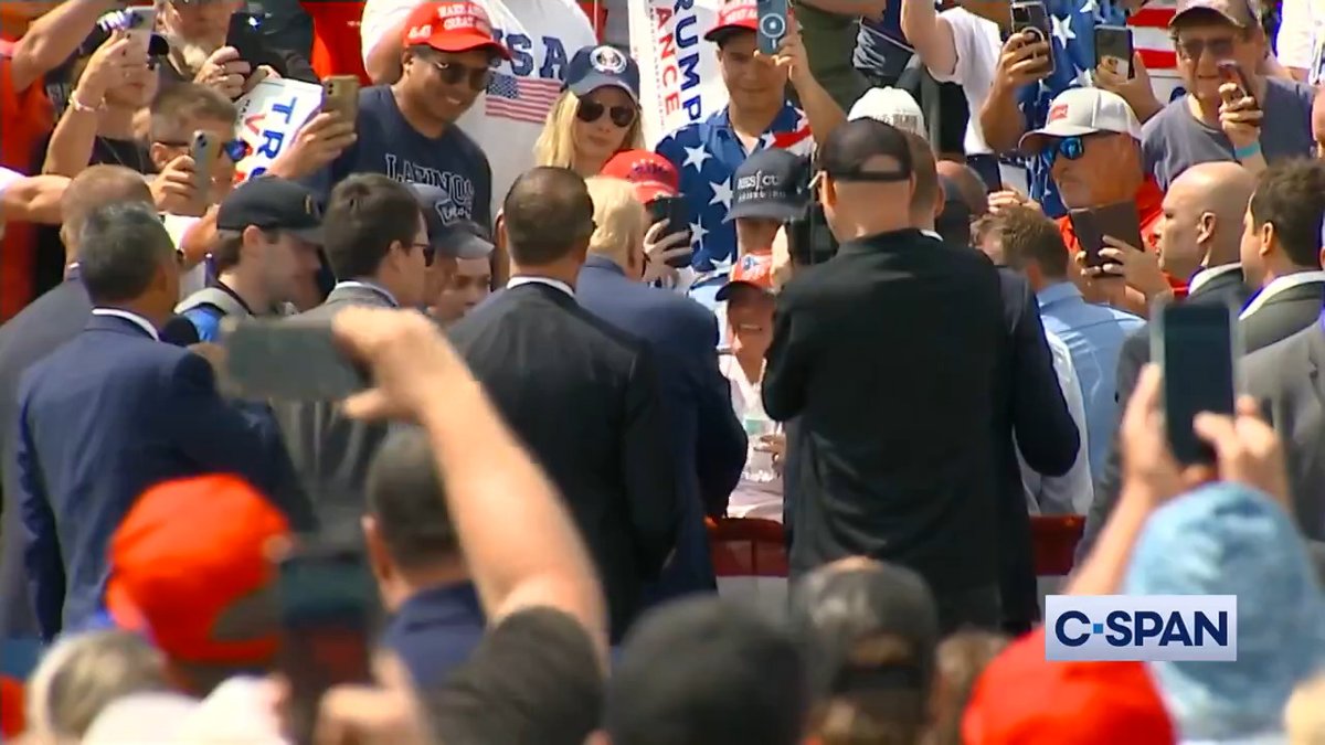 President Trump pauses his remarks and asks for a doctor to help someone with a medical emergency in the crowd. He walks over, speaks with the supporter with the medical issue and hugs them before returning to the stage and resuming his remarks.