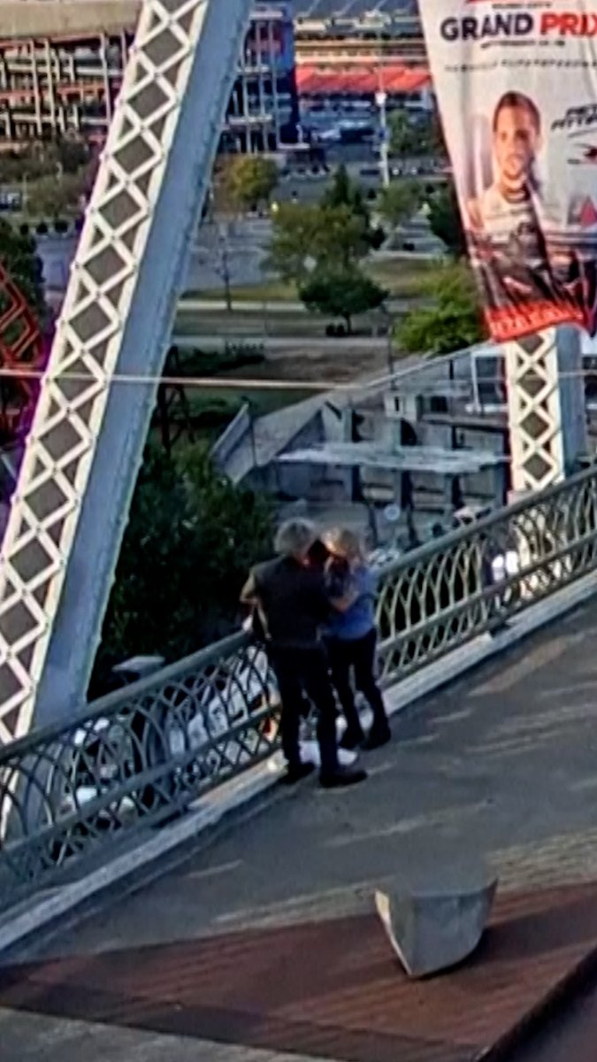 VIDEO: US musician Jon Bon Jovi was shooting a video on the John Seigenthaler Pedestrian Bridge in Nashville, Tennessee when he and another person saw a woman standing outside the guard railing of the bridge and helped her to safety. #AFPVertical