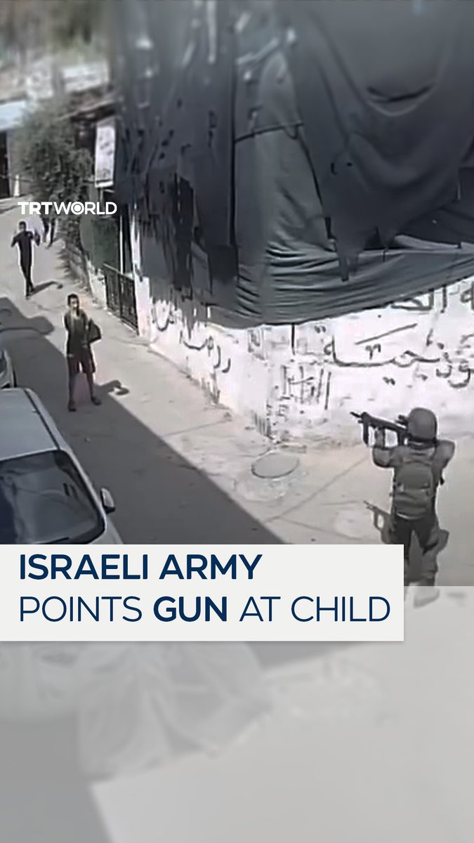 An Israeli soldier is caught on CCTV pointing a gun at children during a raid in Hebron in the occupied West Bank