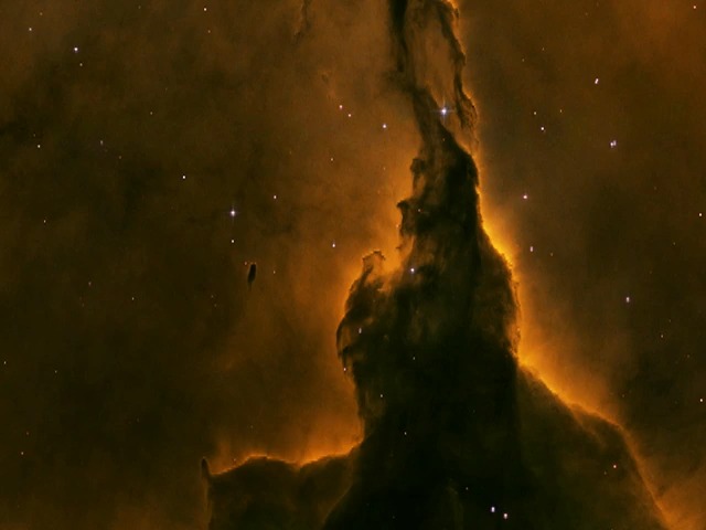 It would take more than nine years for light to travel the length of this pillar of gas and dust in the Eagle Nebula. Eventually the ultraviolet light from the offscreen stars that leave it silhouetted against the nebula will erode the pillar completely. Credit: Hubble/NASA, ESA.