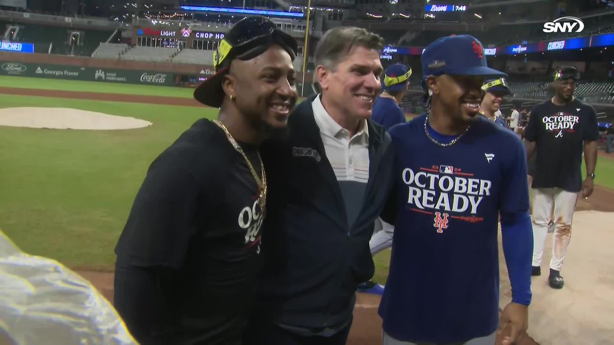 Members of the Mets and Braves join up on the field to congratulate each other on making the postseason