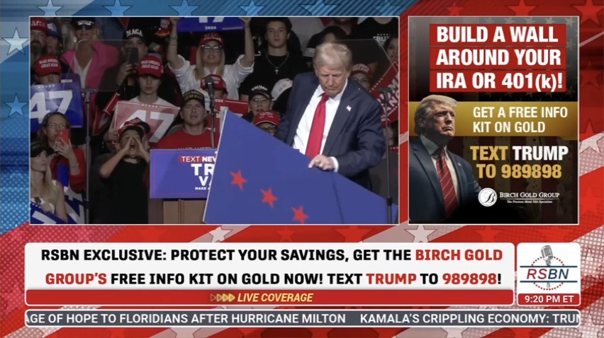 Trump moves a sign because it’s blocking his handler-written teleprompter script