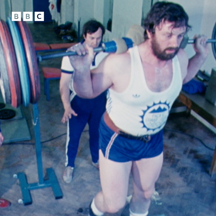 Geoff Capes, British shot put record holder and two-time world's strongest man, has died aged 75. In 1976, Tonight spent some time with him as he prepared for the Olympics lifting tonnes of weights, consuming countless calories and breeding budgies.