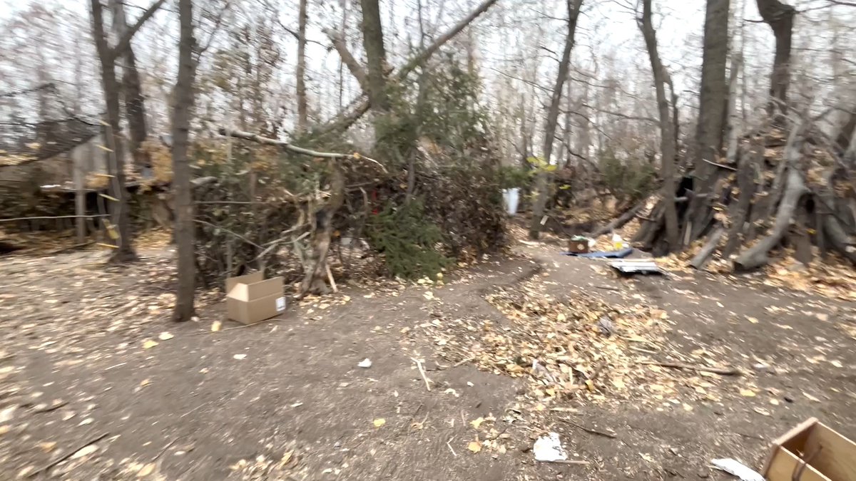 Police say it is one of most elaborate encampments they have ever seen, with a mini-power grid, including solar panels, and multiple home appliances. The encampment was discovered last week by the City of Edmonton and Edmonton Police Service joint response encampment team. It was almost completely camouflaged and included four multi-level structures surrounded by a fence made of trees and broken branches. The structures had been built without nails or other forms of support and were at risk of collapse. Inside, police and park rangers found fire-stoves with lit fires, a stone fireplace, stone/marble flooring, a working fridge and washing machine, and live electrical wires strung haphazardly. Power was supplied by four generators, with solar panels powering a chop shop for stolen bikes. 15 weapons, including three guns, and about $8000 worth of stolen goods were recovered. Police have so far returned 2 backpack blowers and 1 mountain bike to their rightful owners. 20 violation tickets were written, and 10 warrants executed. The encampment caused significant environmental damage to the trees and root systems, and the nearby creek was dammed in multiple places to provide running water to one of the structures. The encampment has since been dismantled. Those living in it were offered access to services and supports, which they refused.