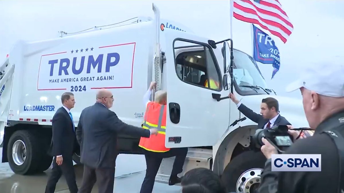 Former President Trump answers questions while sitting in a garbage truck in Green Bay, WI.